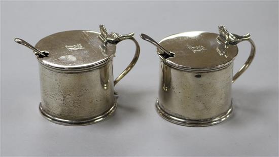 A pair of George V silver drum mustards, Thomas Bradbury & Sons, Sheffield, 1923 and a pair of earlier condiment spoons.